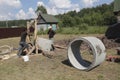 Workers install concrete rings in the well