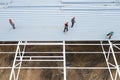 Workers install the roof of a modern frame building. Top view from a drone