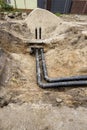 Construction site showing new underground piping installation in a recently excavated area Royalty Free Stock Photo