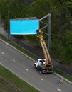 Workers Installing blank blue billboard outdoor