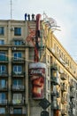 Workers installing big glass of Coca Cola advertising on a tall building, Bucharest, Romania Royalty Free Stock Photo