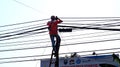 Workers installing internet cables over poles, Royalty Free Stock Photo