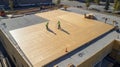 Workers Installing Plywood Sheeting on a Flat Roof Royalty Free Stock Photo