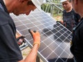 Workers installing solar panel on metal beams Royalty Free Stock Photo