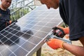 Workers installing solar panel on metal beams Royalty Free Stock Photo