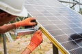 Workers installing solar panel on metal beams Royalty Free Stock Photo