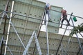 Workers installing solar panels on metal beams Royalty Free Stock Photo