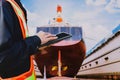 Workers with Ipad in hand holding on floating dock yard Stern propeller, rudder and shafting port controller, Royalty Free Stock Photo