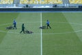 Workers lawnmowers mowing lawn on football field using grass-cutters Royalty Free Stock Photo