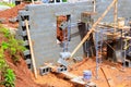Construction workers build block wall structure at new site on works day Royalty Free Stock Photo