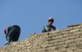 Workers lay brick in Baku, Azerbaijan - Baku - Black & White Royalty Free Stock Photo