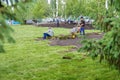 Workers are laying sod lawn rolls. Landscaping of yard, landscaping of city park. Yfa, Russia - 28.06.2019 Royalty Free Stock Photo