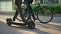 Workers legs stepping city in morning closeup. Corporate people with scooter Royalty Free Stock Photo