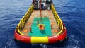 Workers are lifted by the crane to the offshore platform, Transfer crews by personal basket from crews boat to the platform. Royalty Free Stock Photo