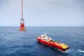 Workers are lifted by the crane to the offshore platform, Transfer crews by personal basket from the platform to crews boat Royalty Free Stock Photo