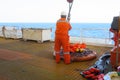 Workers are lifted by the crane to the offshore platform