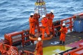 Workers are lifted by the crane to the offshore platform