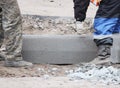 Workers are lifting concrete curb. Concrete kerb installation at sidewalk edging. Sidewalk replacement Royalty Free Stock Photo