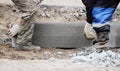 Workers are lifting concrete curb. Concrete kerb installation at sidewalk edging. Sidewalk replacement Royalty Free Stock Photo