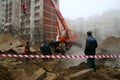 Workers liquidate accident in the yard of an apartment house