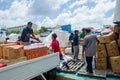 Workers loading goods in supply boat