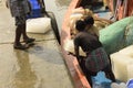 Workers loading ice blocks to the fishing trawler for cargo preservation at Frezarganj Harbor, West Bengal, India