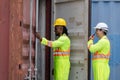 Workers man team inspecting containers box at shipping container cargo, Engineer and foreman working in industry containers yard Royalty Free Stock Photo