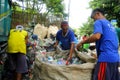 Workers of a materials recovery facility sort through plastic waste and segregate them for proper recycling Royalty Free Stock Photo