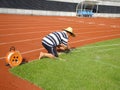 Workers measure the football field on the lawn with a roller rope Royalty Free Stock Photo