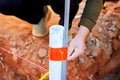Workers measure mark location of pipe during construction in building site Royalty Free Stock Photo