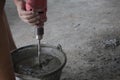 Workers mixing cement using an electric drill Royalty Free Stock Photo