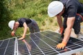 Workers mounting photovoltaic solar panel system. Royalty Free Stock Photo