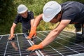 Workers mounting photovoltaic solar panel system Royalty Free Stock Photo