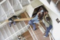 Workers move the safe on a lstaircase