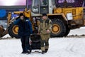 Workers move a snow generating machine