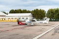 Workers moving Cessna 172 SP airplane to hangar. Royalty Free Stock Photo