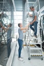 workers next to aluminum ladder at warehouse Royalty Free Stock Photo