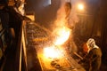 Workers operates at the metallurgical plant. Melting Iron in the foundry. Liquid metal in the factory, smelting iron and