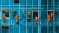 Workers in Orange Suits Cleaning Windows of Modern Skyscraper Royalty Free Stock Photo