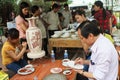 Workers paint on ceramics