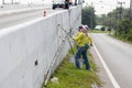 Workers paint white color on the road