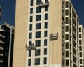 Workers painting the external facade