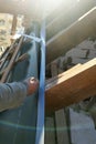 Workers paste adhesive tape on the roof rafters and attach a hydroscope to it Royalty Free Stock Photo