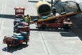 Workers placing luggage in trailer to load an airplane at Bilbao Airport