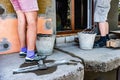 Workers plastering facade on construction site. Royalty Free Stock Photo