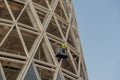 Workers on a platform in mobile safety while installing the electrical system at the bibioteca del bosco in the isola district of