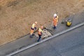 Workers plug a hole in the sidewalk removing the old asphalt to install a new one - Moscow, Russia, may 18, 2020