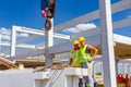 Workers are posing at work, attaching crane hooks to concrete joist in truck trailer on construction site Royalty Free Stock Photo