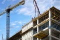 Workers pour concrete at the construction site of a new residential building