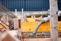 workers pouring concrete with concrete pump. Details of construction site